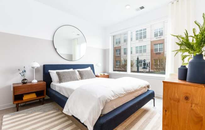 a bedroom with a bed and a large window at Dey & Bergen, Harrison, New Jersey