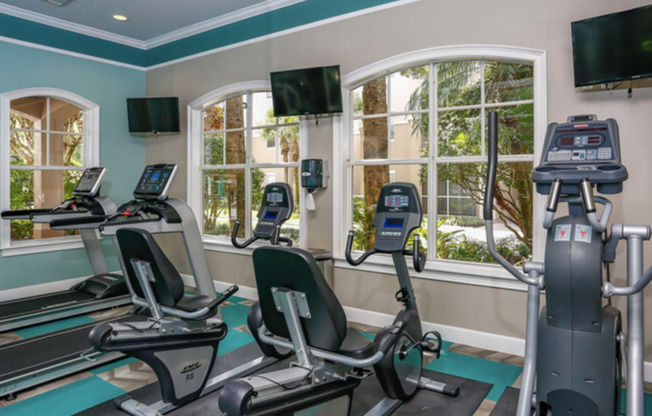 Legends at Championsgate apartments fitness center with cardio equipment bikes, treadmill and elliptical