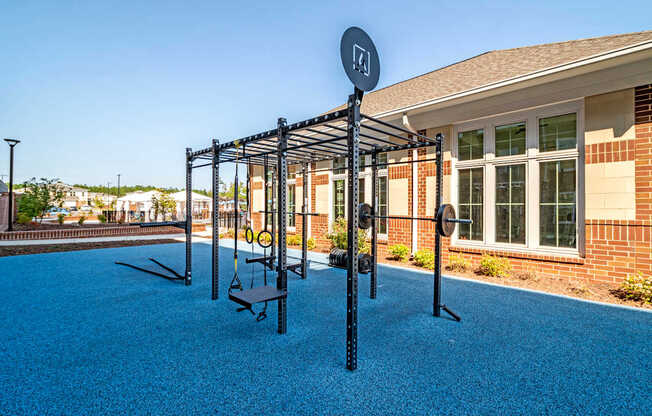 A playground with a swing set and a sign that says "H".