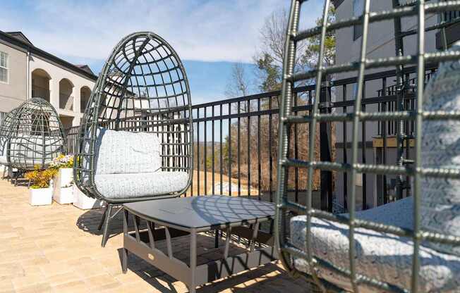 a seating area with chairs and a table on a balcony