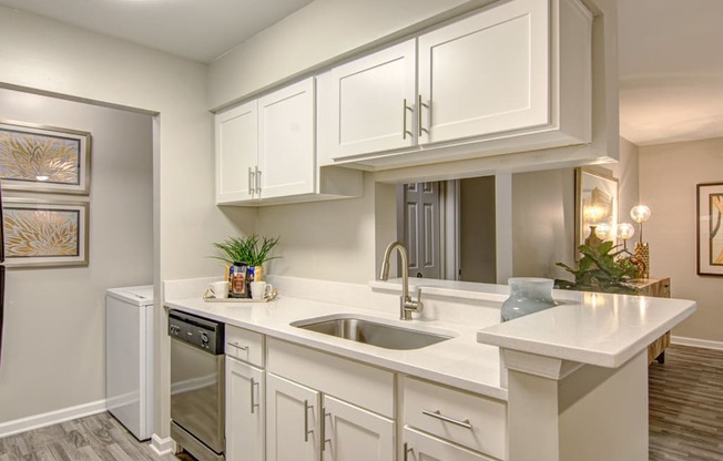 a kitchen with white cabinets and a sink at Hunters Chase Apartments, Midlothian, Virginia