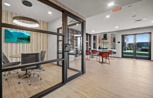 a conference room with glass sliding doors and a table with chairs