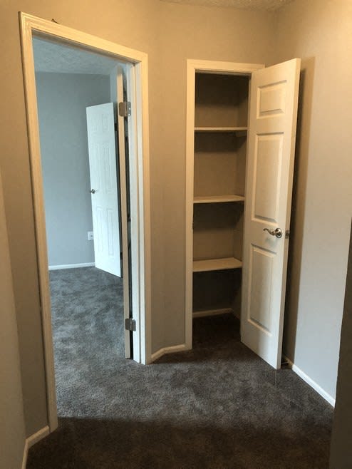 a room with a closet and an open door