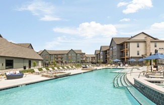 the resort style pool with lounge chairs at the resort at governors crossing at Notch66, Colorado