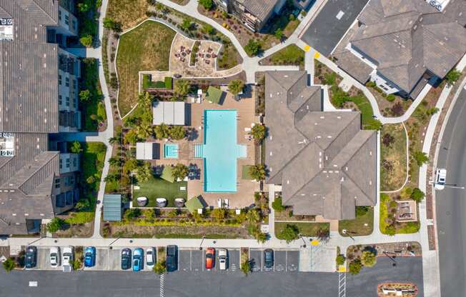 a house with a large pool in the middle of a parking lot