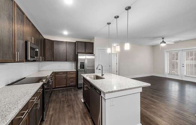 A kitchen with dark wood cabinets and a white countertop.