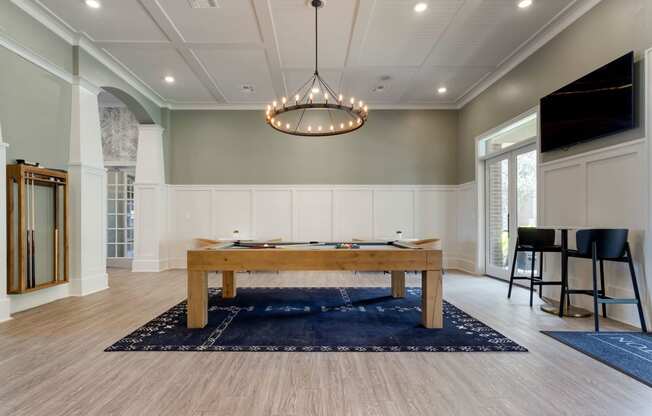 a game room with a pool table and a tv at Madison on the Meadow, Stafford, TX