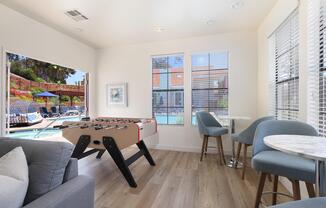 a living room filled with furniture and a large window