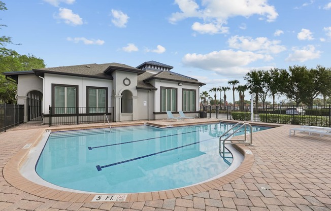 A small pool in front of a house.