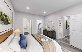 a white bedroom with a bed and a mirror