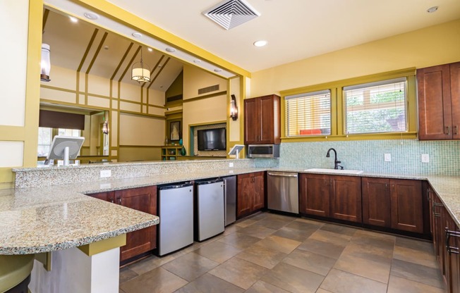 clubhouse kitchen with granite counter tops and stainless steel appliances