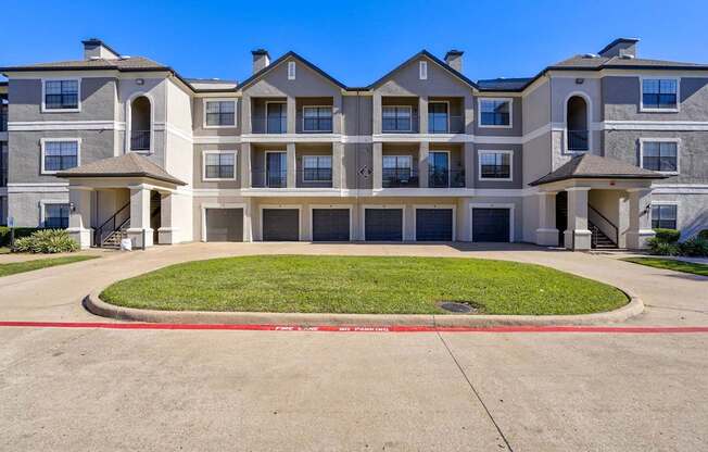 A large apartment complex with a red line painted on the ground.