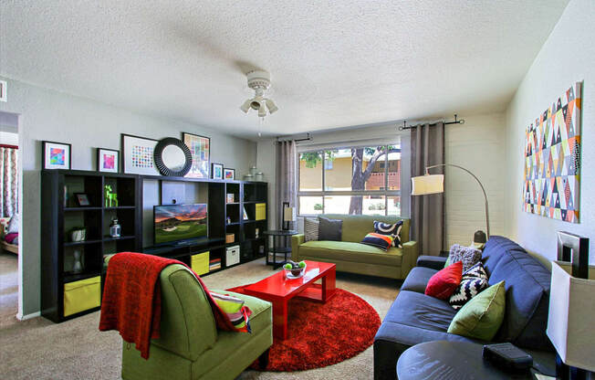 a living room filled with furniture and a large window