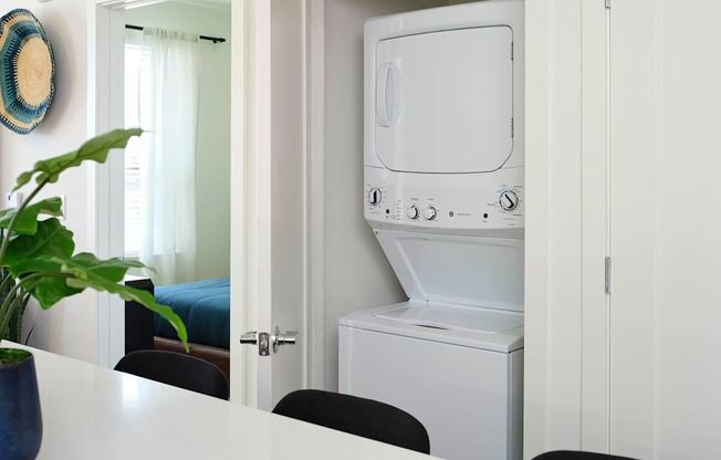 a white washer and dryer in a white laundry room