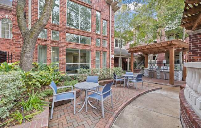 A patio with tables and chairs near outdoor grills