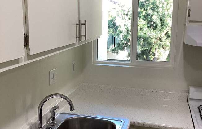 A kitchen with a sink and a window.