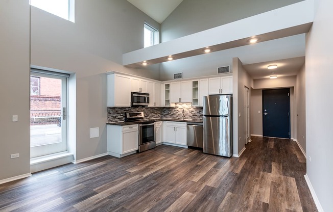 an open kitchen with stainless steel appliances and a large window