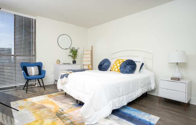 bedroom with white nightstand and light, large windows at Vera Cortez Hill, San Diego, CA, 92101