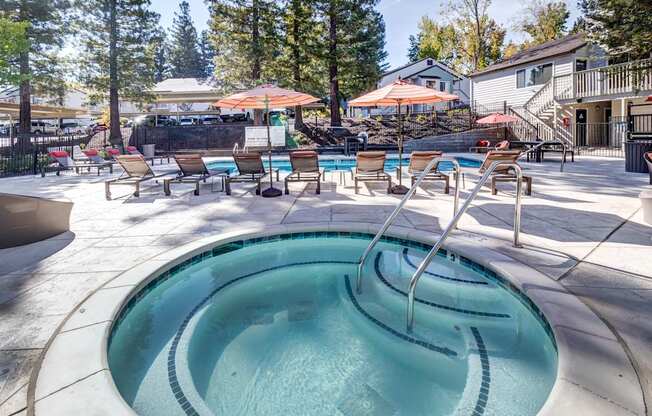 A small pool with a waterfall in the middle of it.