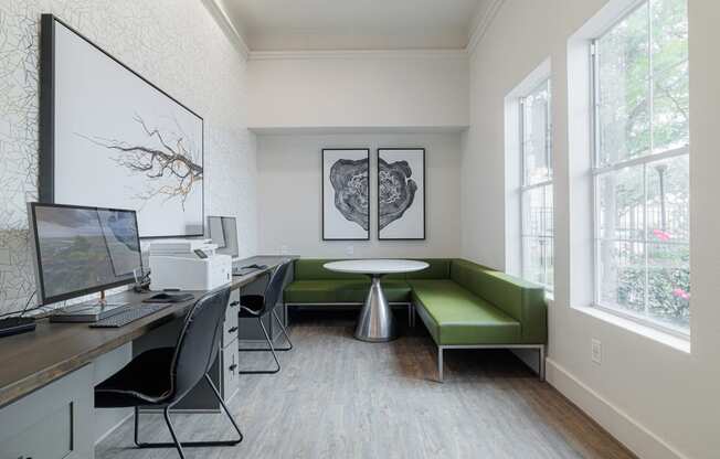 a room with a computer desk and a green couch