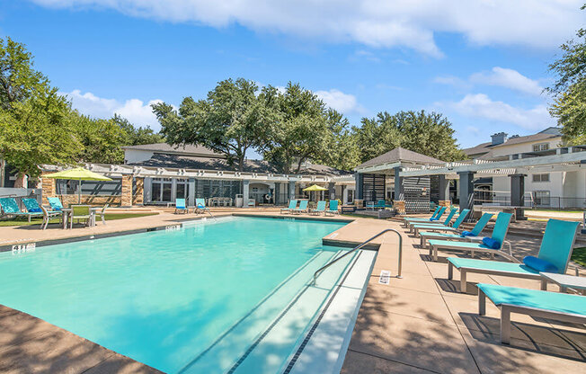 Community Swimming Pool with Pool Furniture at Allure North Dallas Apartments in Dallas, TX.