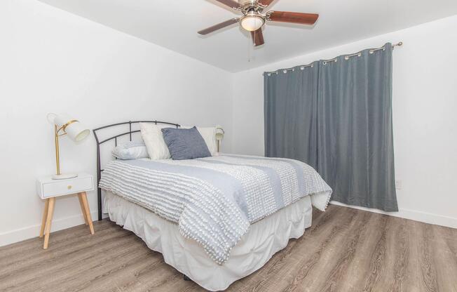 a bedroom with a bed and desk in a small room