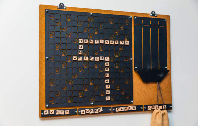 a wooden game board with numbers on it and a shovel