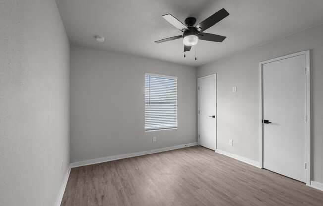Photo of newly renovated bedroom with vinyl flooring and ceiling fan at Sunset Heights, San Antonio, 78209