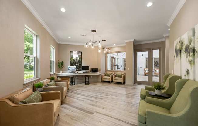 a living room with couches and chairs and a desk