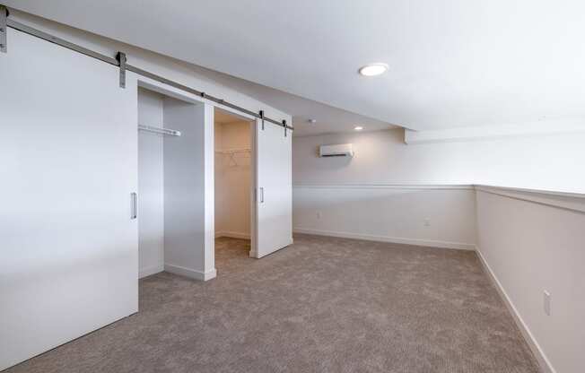 a bedroom with a closet and a carpeted floor at Marina Square, Washington, 98337