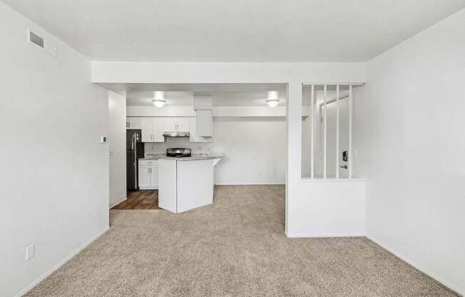 living and dining room with plush carpeting  at Trappers Cove Apartments, Lansing, MI