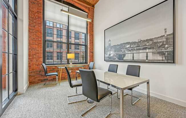 a conference room with a table and chairs and a large window