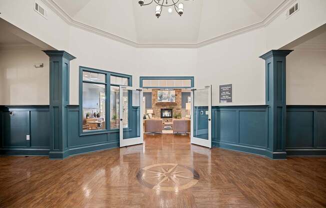 A room with a wooden floor and a chandelier.