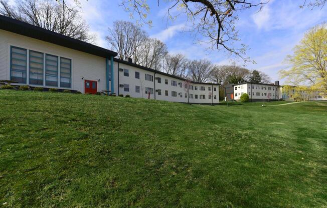 Lush green lawn and mature trees outside of The Flats at Jackson Square