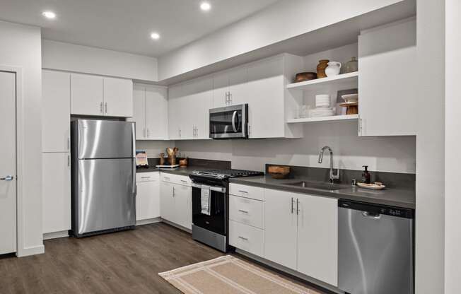 a kitchen with white cabinets and stainless steel appliancesat Westbury Apartments, Rancho Cucamonga, 91739