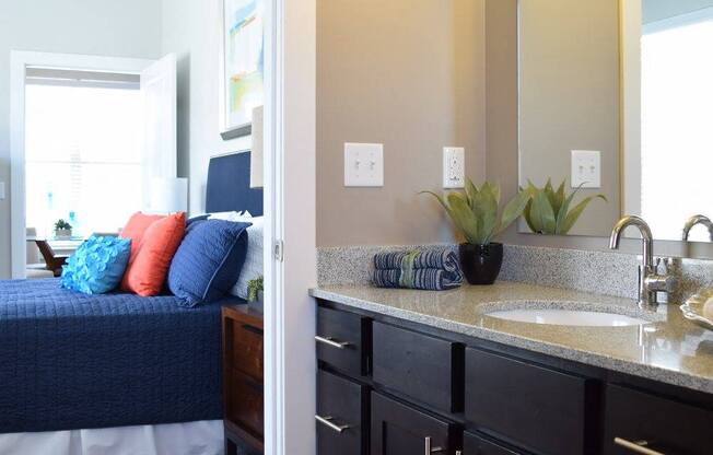 A bathroom with a blue bed in the corner.