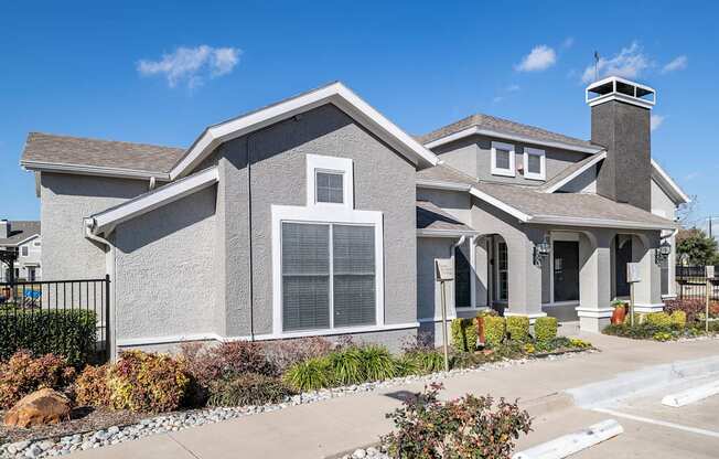 a house with a yard and a sidewalk in front of it