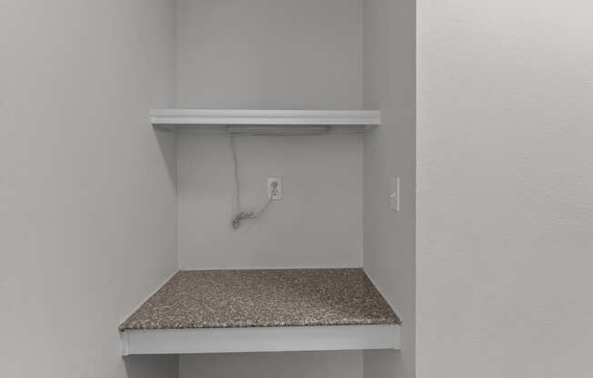 the closet in a bedroom of a house with an electrical outlet