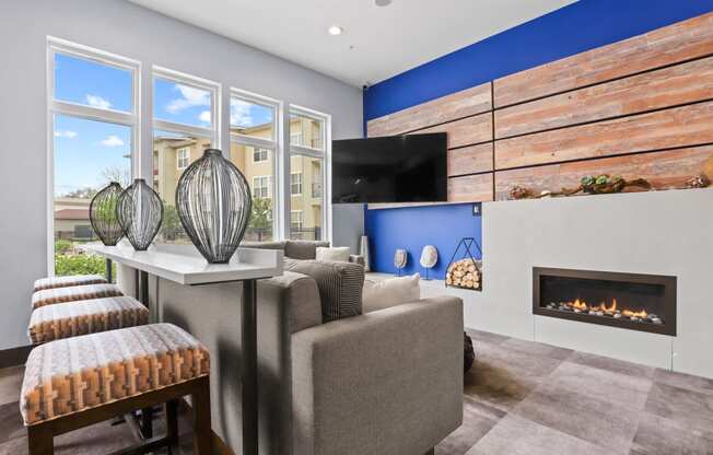 a living room with a blue accent wall and a fireplace