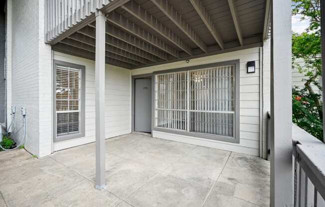 the front porch of B1 at Woodlands of Plano Apartments in Plano, Texas