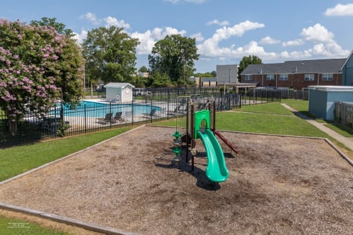 a playground with a slide and a pool in a yard