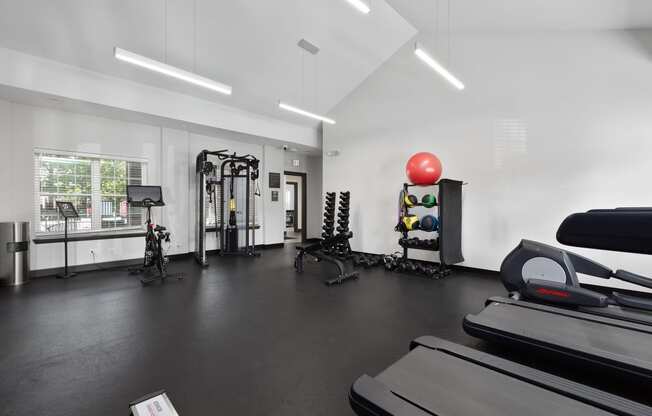 the gym with treadmills and weights at the belgard apartments