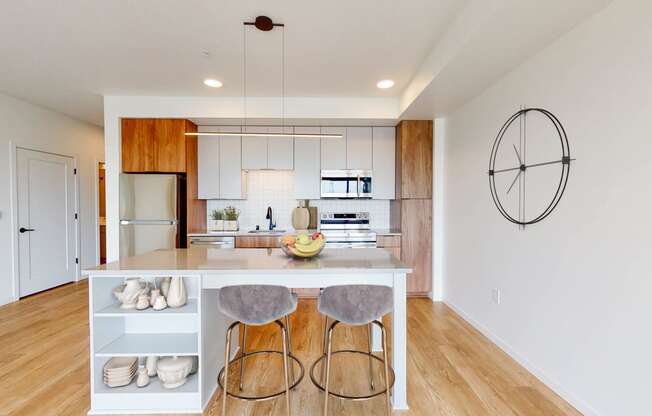 a kitchen with a island and three stools