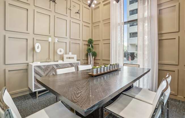 a dining room with a table and chairs and a window