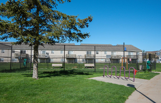 a playground in a park in front of an apartment building