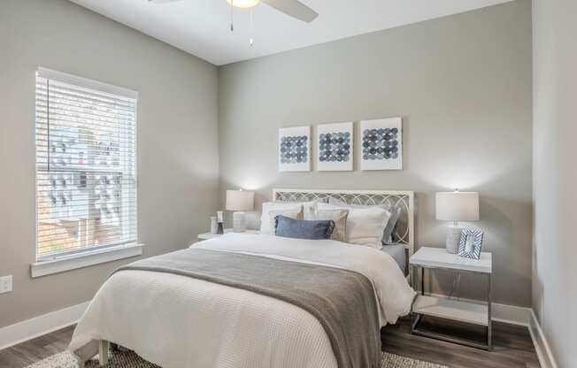 a bedroom with a bed and a ceiling fan