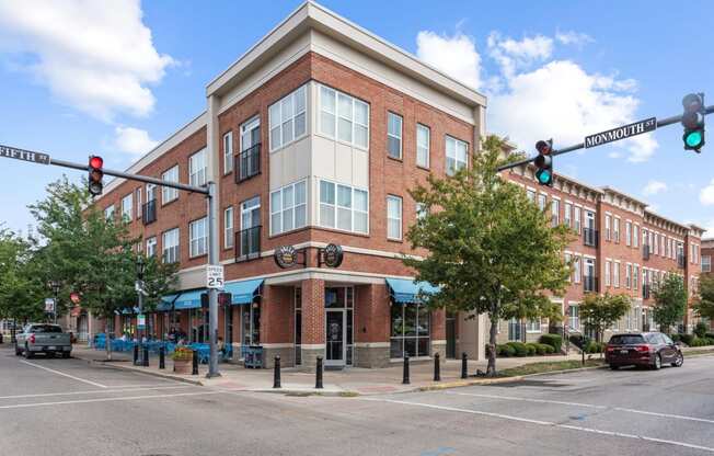 a brick building on the corner of a street with a traffic light