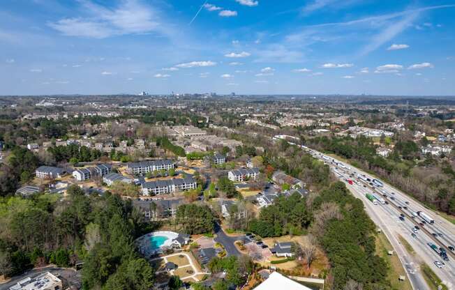 a aerial view of a neighborhood of houses and a highway