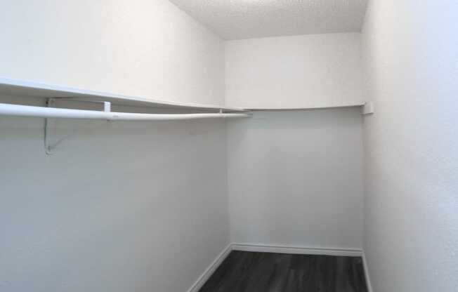 a walk in closet in a studio apartment