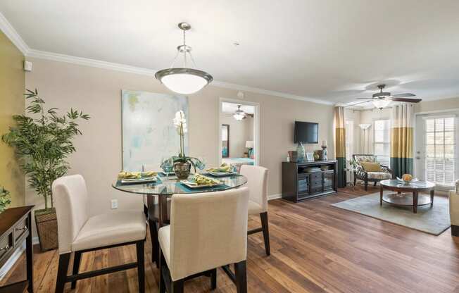 a living room and dining room with a table and chairs